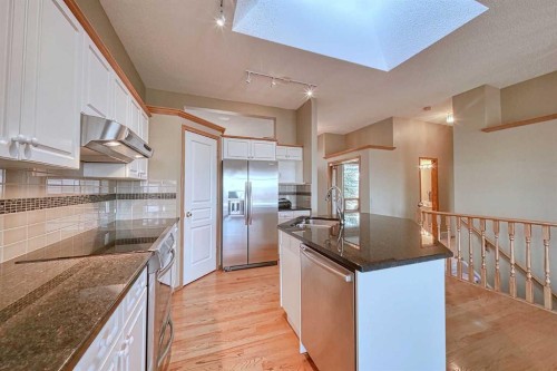 54 Eagleview Way, Cochrane, AB - Indoor Photo Showing Kitchen With Double Sink With Upgraded Kitchen