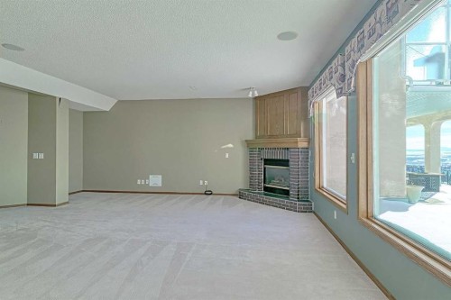 54 Eagleview Way, Cochrane, AB - Indoor Photo Showing Other Room With Fireplace