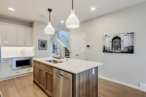92 Creekside Street Sw, Calgary, AB - Indoor Photo Showing Kitchen With Double Sink