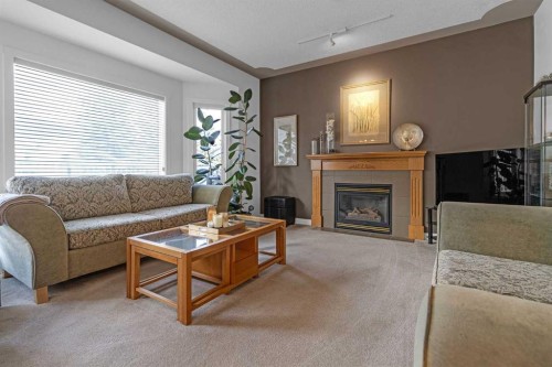28 Prominence View Sw, Calgary, AB - Indoor Photo Showing Living Room With Fireplace