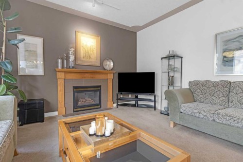 28 Prominence View Sw, Calgary, AB - Indoor Photo Showing Living Room With Fireplace