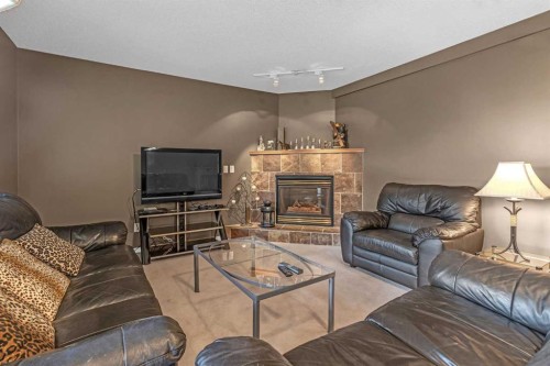 28 Prominence View Sw, Calgary, AB - Indoor Photo Showing Living Room With Fireplace