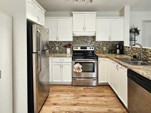 94 Hidden Spring Green Nw, Calgary, AB - Indoor Photo Showing Kitchen With Double Sink