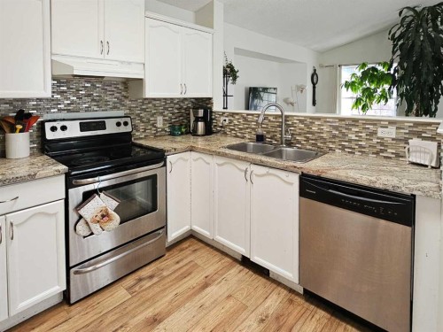 94 Hidden Spring Green Nw, Calgary, AB - Indoor Photo Showing Kitchen With Double Sink With Upgraded Kitchen