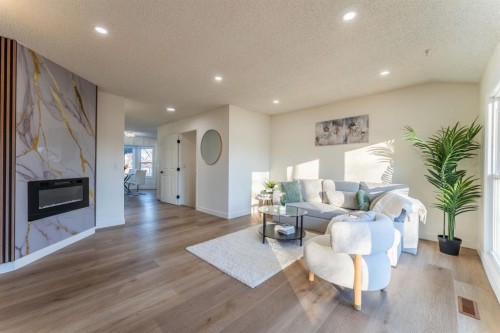 344 Templeview Drive Ne, Calgary, AB - Indoor Photo Showing Living Room With Fireplace