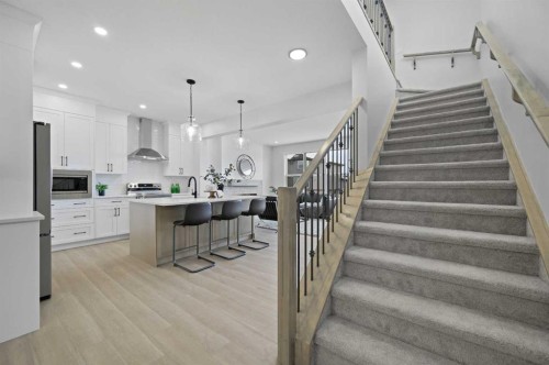 111 Fireside Street, Cochrane, AB - Indoor Photo Showing Kitchen With Upgraded Kitchen