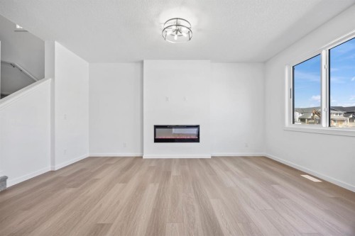 2321 Lancaster Heights Se, Airdrie, AB - Indoor With Fireplace
