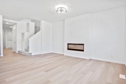2321 Lancaster Heights Se, Airdrie, AB - Indoor With Fireplace