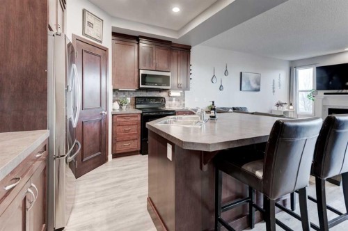 44 New Brighton Landing Se, Calgary, AB - Indoor Photo Showing Kitchen With Double Sink