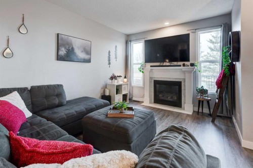 44 New Brighton Landing Se, Calgary, AB - Indoor Photo Showing Living Room With Fireplace