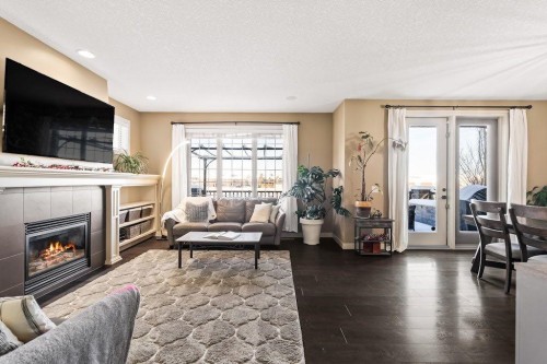 111 Marquis Cove Se, Calgary, AB - Indoor Photo Showing Living Room With Fireplace