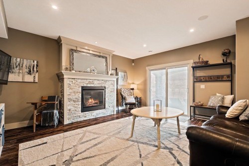 111 Marquis Cove Se, Calgary, AB - Indoor Photo Showing Living Room With Fireplace