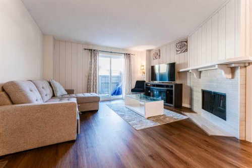 1101-829 Coach Bluff Crescent Sw, Calgary, AB - Indoor Photo Showing Living Room With Fireplace