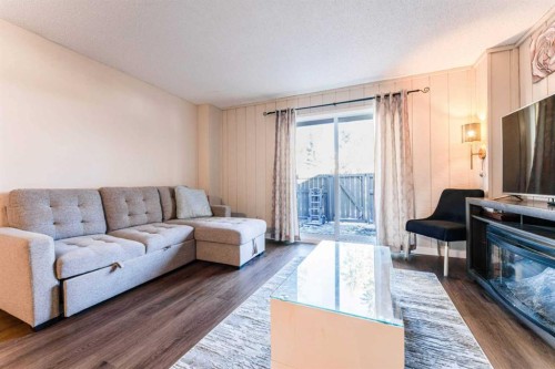 1101-829 Coach Bluff Crescent Sw, Calgary, AB - Indoor Photo Showing Living Room With Fireplace