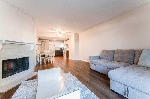 1101-829 Coach Bluff Crescent Sw, Calgary, AB - Indoor Photo Showing Living Room With Fireplace