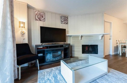 1101-829 Coach Bluff Crescent Sw, Calgary, AB - Indoor Photo Showing Living Room With Fireplace