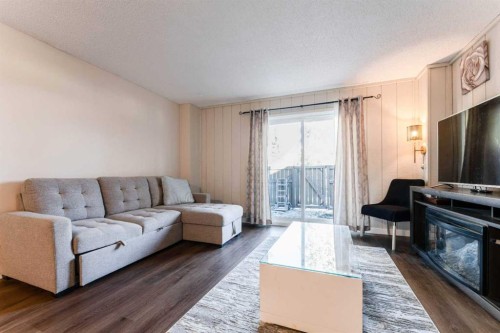 1101-829 Coach Bluff Crescent Sw, Calgary, AB - Indoor Photo Showing Living Room