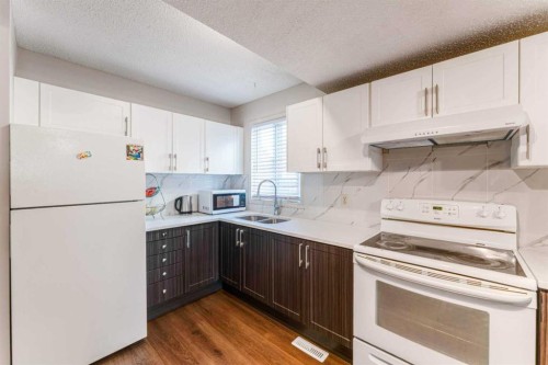 1101-829 Coach Bluff Crescent Sw, Calgary, AB - Indoor Photo Showing Kitchen With Double Sink