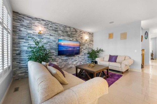 2233 Bayside Circle Sw, Airdrie, AB - Indoor Photo Showing Living Room With Fireplace
