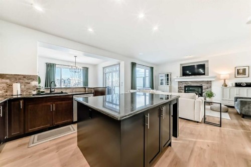 135 Autumn Close Se, Calgary, AB - Indoor Photo Showing Kitchen With Fireplace