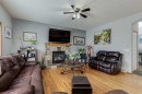 144 Bow Ridge Drive, Cochrane, AB  - Indoor Photo Showing Living Room With Fireplace 