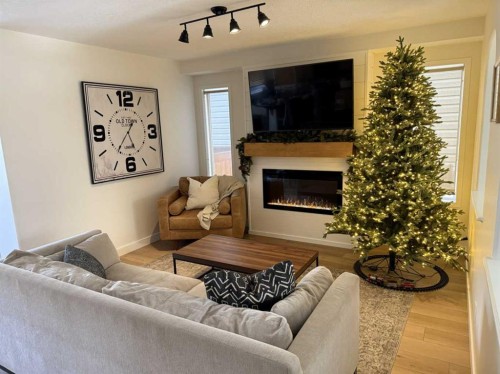 143 Prestwick Heath Se, Calgary, AB - Indoor Photo Showing Living Room With Fireplace