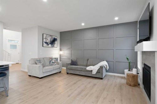 21 Seton Parade Se, Calgary, AB - Indoor Photo Showing Living Room With Fireplace