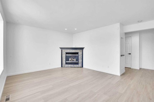 30 New Brighton Circle Se, Calgary, AB - Indoor Photo Showing Living Room With Fireplace
