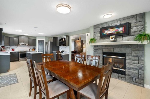 124 Cresthaven Place Sw, Calgary, AB - Indoor Photo Showing Dining Room With Fireplace