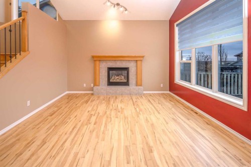 18 Hidden Creek Point Nw, Calgary, AB - Indoor Photo Showing Living Room With Fireplace