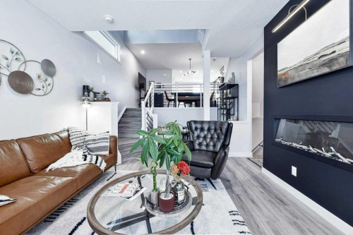 207 Aquila Way Nw, Calgary, AB - Indoor Photo Showing Living Room With Fireplace
