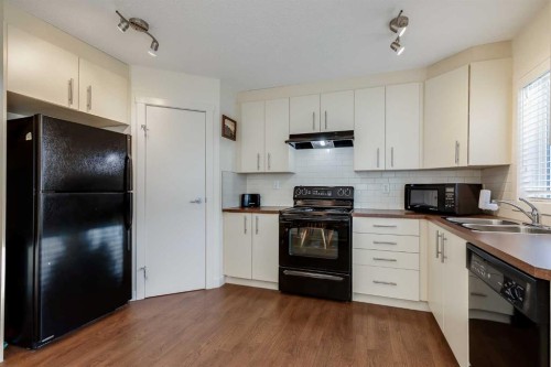 704-2445 Kingsland Road Se, Airdrie, AB - Indoor Photo Showing Kitchen With Double Sink