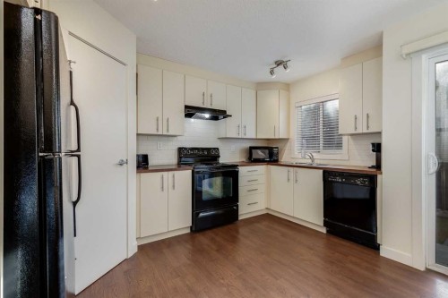 704-2445 Kingsland Road Se, Airdrie, AB - Indoor Photo Showing Kitchen With Double Sink