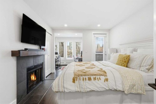 310-1111 13 Avenue Sw, Calgary, AB - Indoor Photo Showing Bedroom With Fireplace