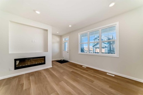 32 Creekside Rise Sw, Calgary, AB - Indoor Photo Showing Living Room With Fireplace