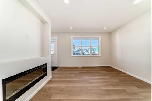 32 Creekside Rise Sw, Calgary, AB - Indoor Photo Showing Other Room With Fireplace