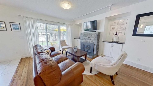 2932 Lathom Crescent Sw, Calgary, AB - Indoor Photo Showing Living Room With Fireplace