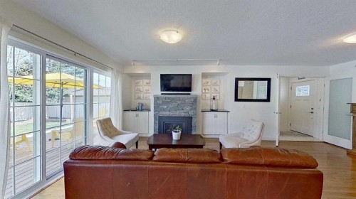 2932 Lathom Crescent Sw, Calgary, AB - Indoor Photo Showing Living Room With Fireplace