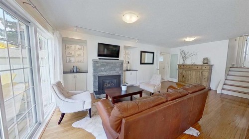 2932 Lathom Crescent Sw, Calgary, AB - Indoor Photo Showing Living Room With Fireplace