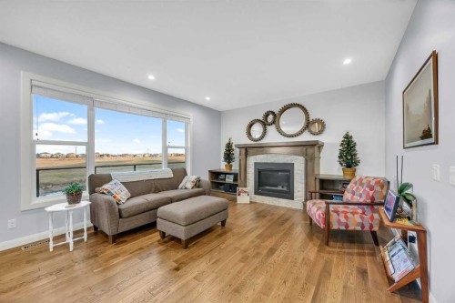 264 Boulder Creek Crescent Se, Langdon, AB - Indoor Photo Showing Living Room With Fireplace