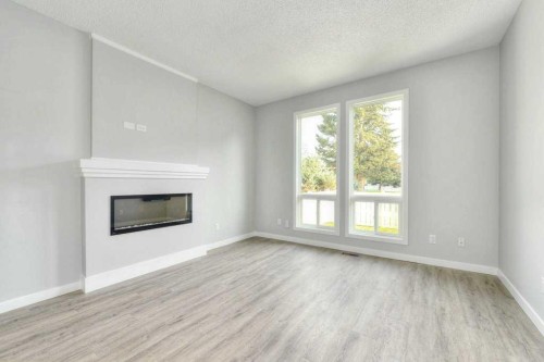 802-5340 17 Avenue Sw, Calgary, AB - Indoor Photo Showing Living Room With Fireplace
