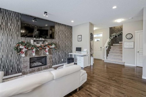 216 Copperpond Green Se, Calgary, AB - Indoor Photo Showing Living Room With Fireplace