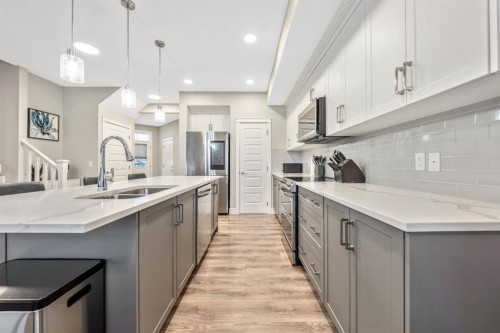 135 Belgian Crescent, Cochrane, AB - Indoor Photo Showing Kitchen With Double Sink With Upgraded Kitchen