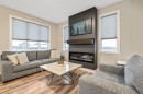 135 Belgian Crescent, Cochrane, AB  - Indoor Photo Showing Living Room With Fireplace 