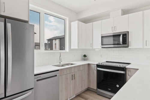 405-301 Redstone Boulevard Ne, Calgary, AB - Indoor Photo Showing Kitchen With Stainless Steel Kitchen With Double Sink With Upgraded Kitchen