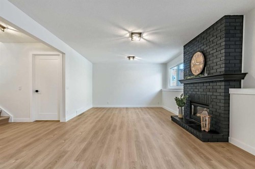 15 Woodford Crescent Sw, Calgary, AB - Indoor With Fireplace