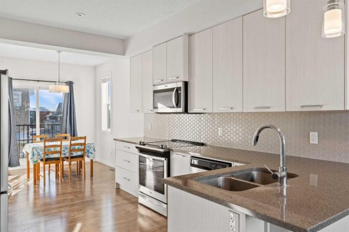901-115 Sagewood Drive Sw, Airdrie, AB - Indoor Photo Showing Kitchen With Double Sink With Upgraded Kitchen
