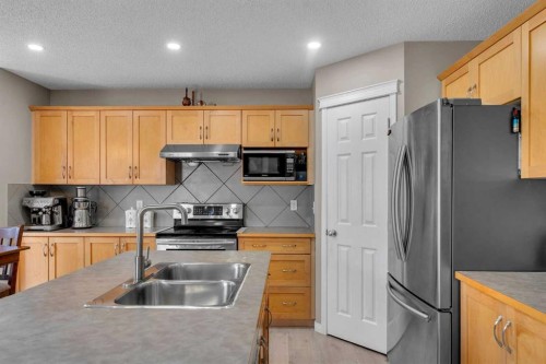 138 Saddlecrest Park Ne, Calgary, AB - Indoor Photo Showing Kitchen With Stainless Steel Kitchen With Double Sink