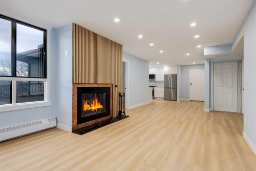 325-2425 90 Avenue Sw, Calgary, AB - Indoor Photo Showing Living Room With Fireplace