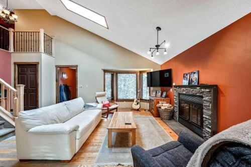 15 Strathlorne Bay Sw, Calgary, AB - Indoor Photo Showing Living Room With Fireplace